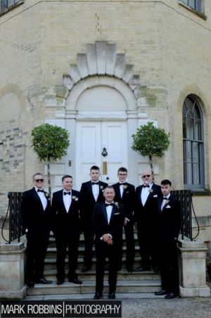 Andy with his groomsmen in Tuxedos