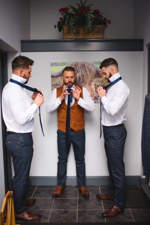 Carl teaching his guys how to tie a tie - Photo by www.emmamoorephotography.co.uk
