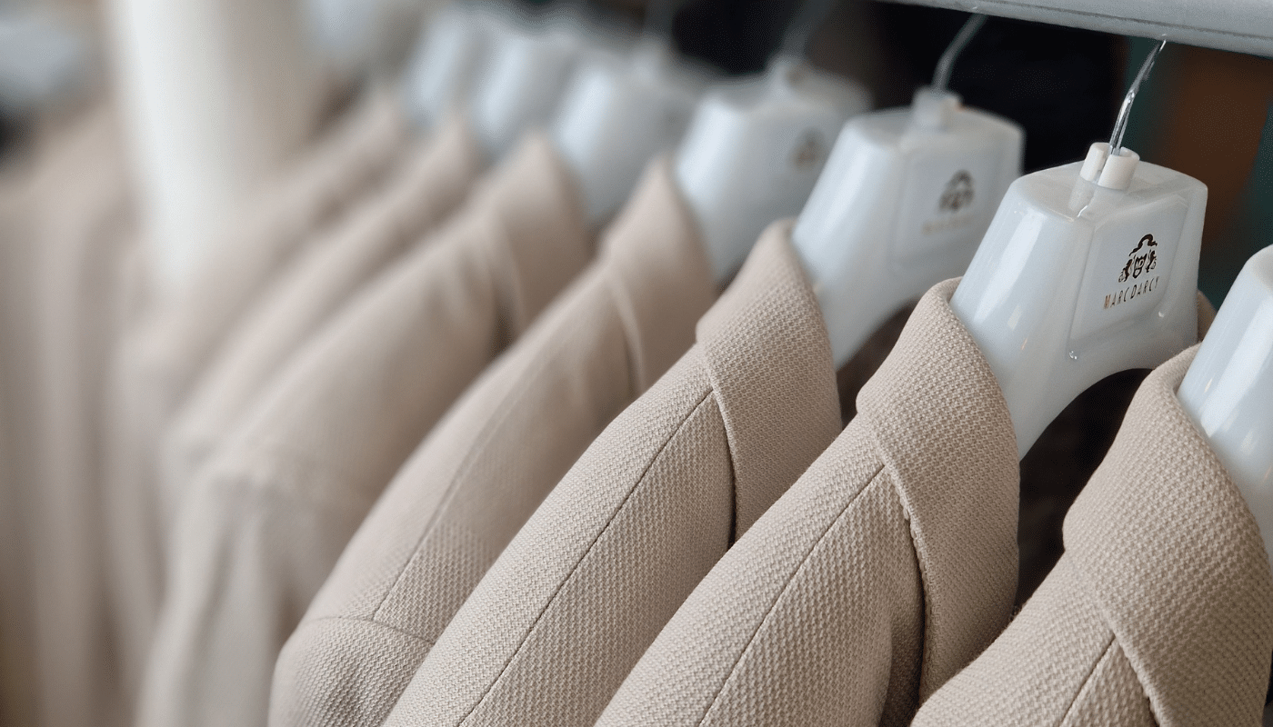 Suits hanging on a rail in a wedding suit shop