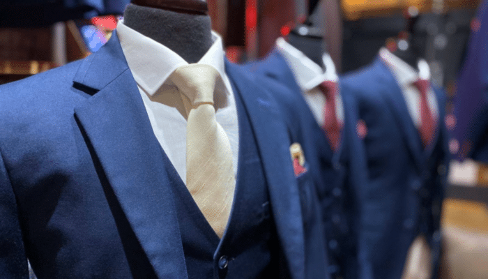 A row of wedding suits on mannequins in a suit store