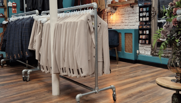 Suits on a rail in a wedding suit shop