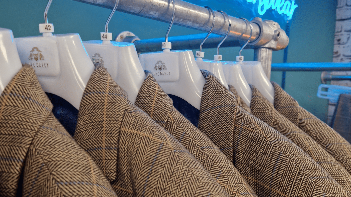 A rail of ted tan tweed marc darcy suits